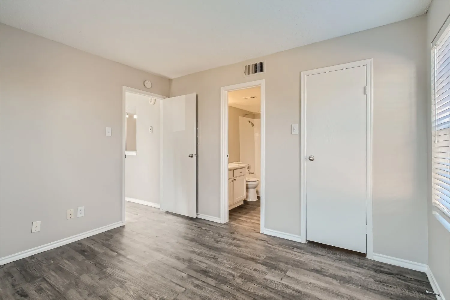 Bedroom, wood-style plank flooring, en-suite bathroom access, closet