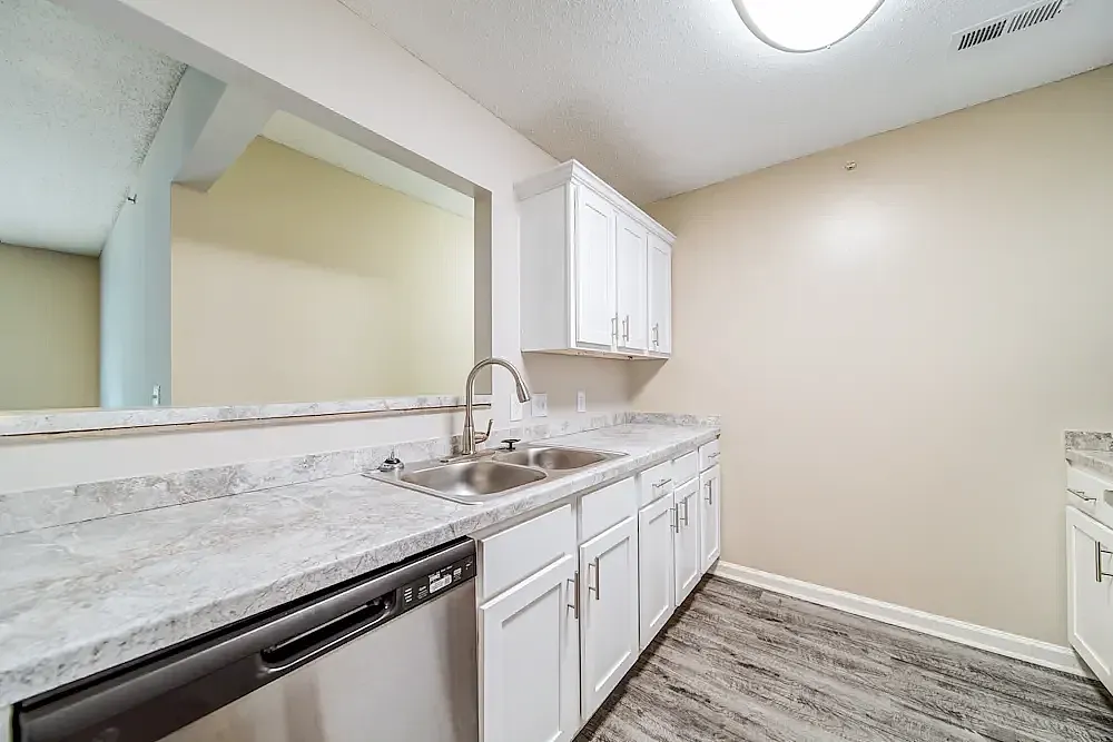Kitchen, white cabinetry, marble countertops, stainless appliances, wood-style plank flooring