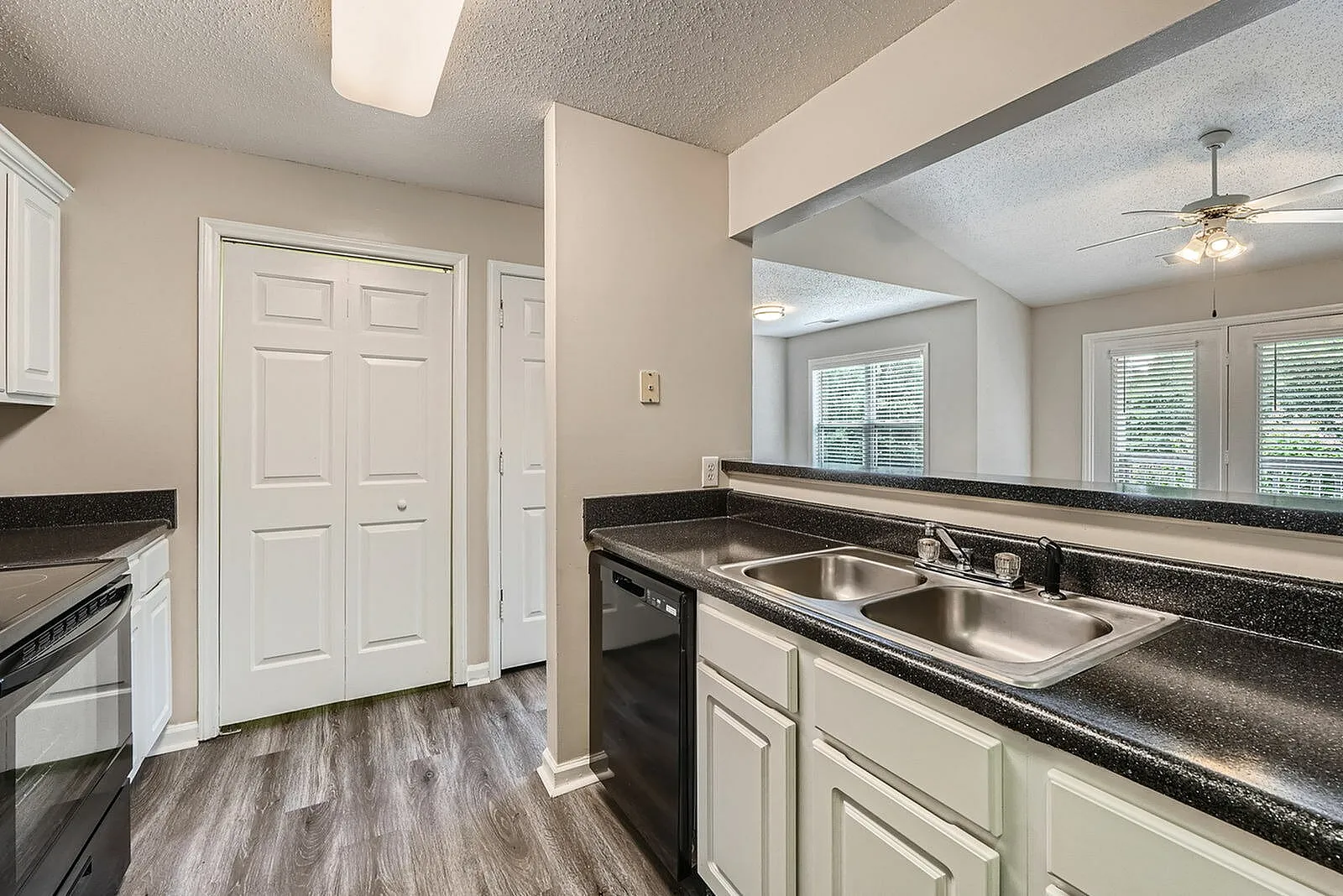 Kitchen, granite countertops, stainless steel sink, cream cabinetry, wood-style plank flooring