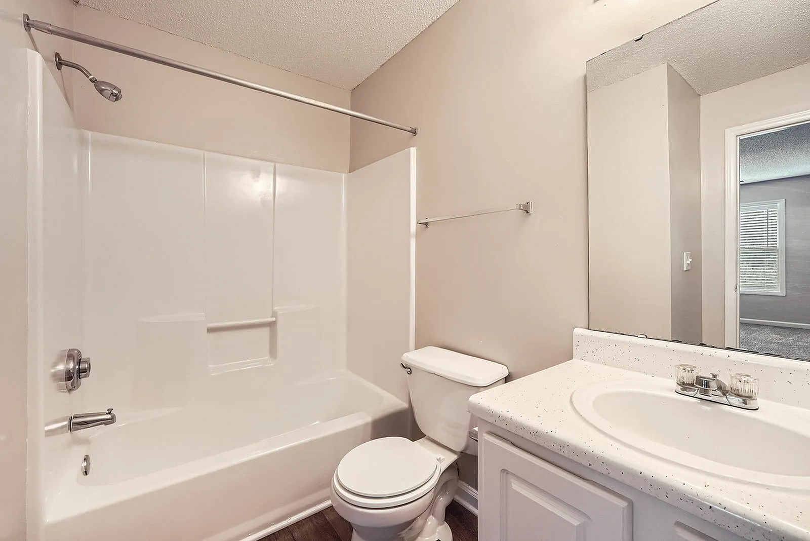 Bathroom, white vanity with sink, toilet, mirror, glass shower enclosure