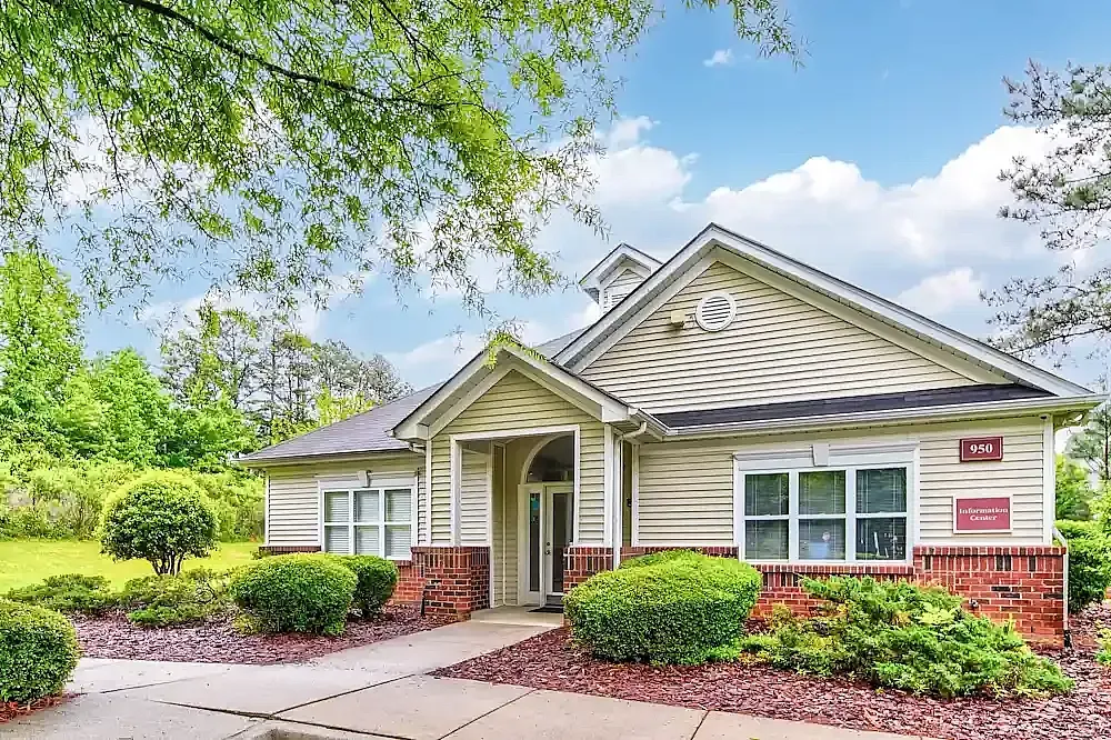 Single-story home, siding, brick foundation, landscaping, driveway