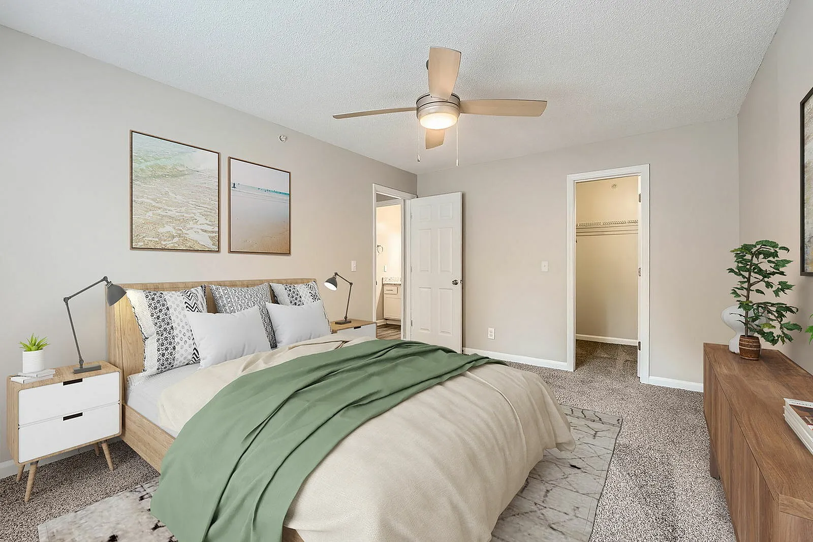 Primary bedroom, wood-style plank flooring, ceiling fan, dual entry doors, green bedding