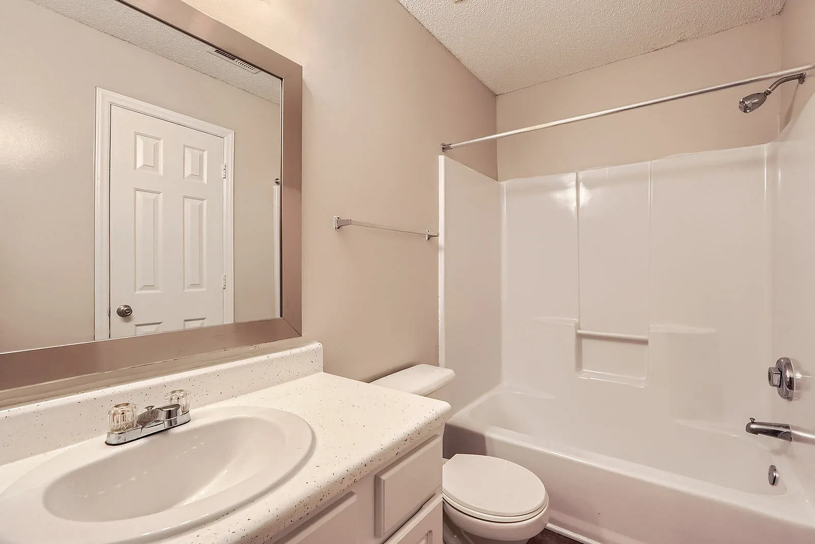 Bathroom, round sink, mirrored vanity, white subway tile shower enclosure, toilet
