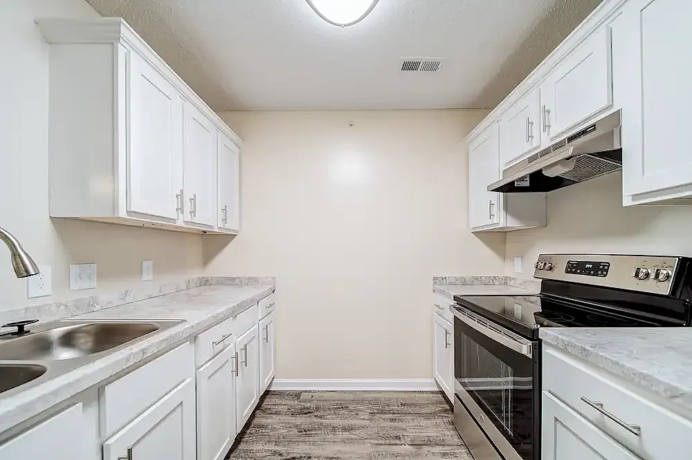 Kitchen, white shaker cabinetry, quartz countertops, stainless steel appliances, wood-style plank flooring