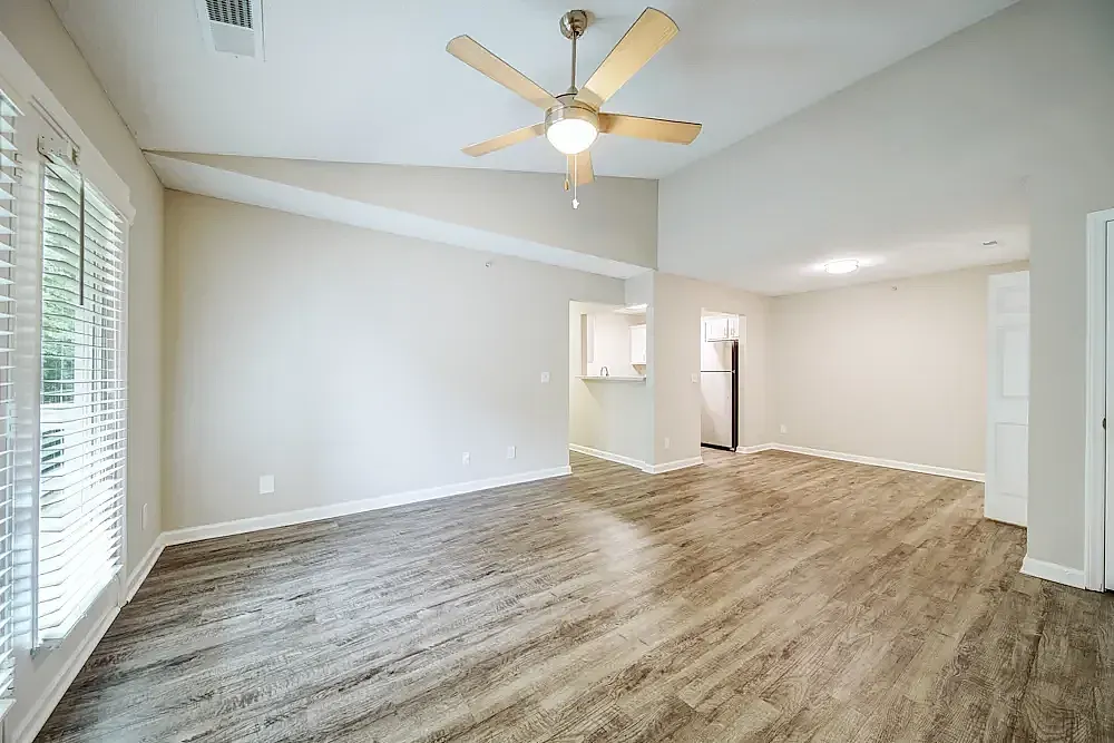 Living room, wood-style plank flooring, ceiling fan with light, open floor plan