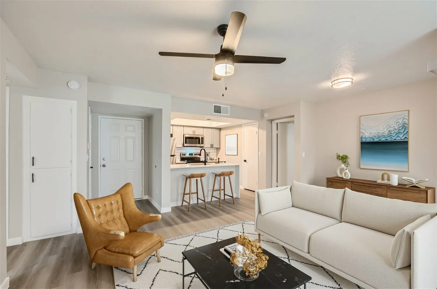 B1 Platinum open living area, kitchen breakfast bar, entry door, wood-style plank flooring