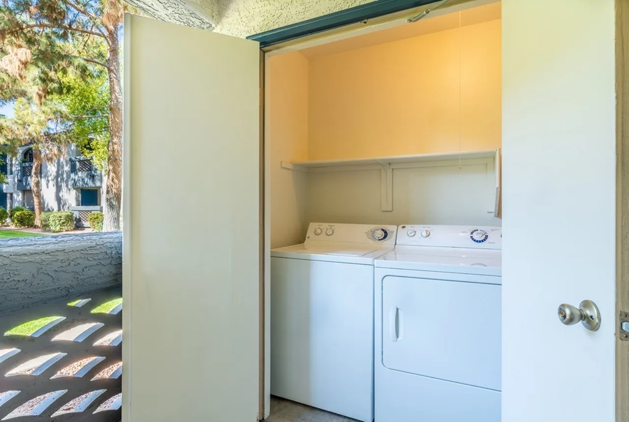 Patio laundry closet, stacked side-by-side washer and dryer, overhead shelf