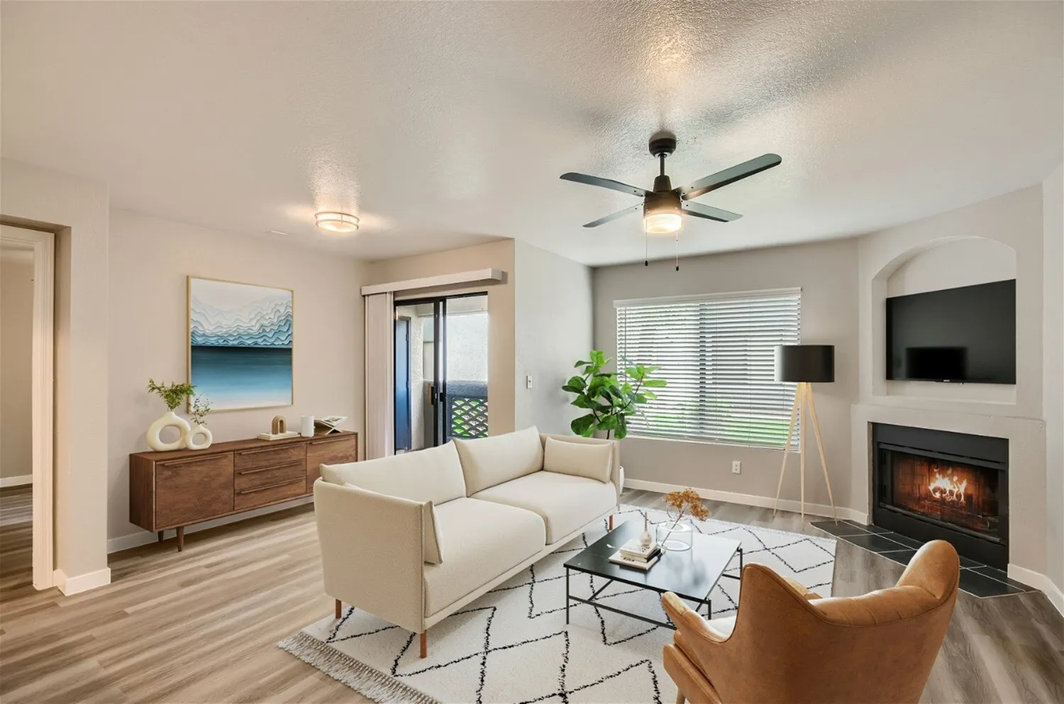 Living room, sliding glass door, window with horizontal blinds, wood-style plank flooring