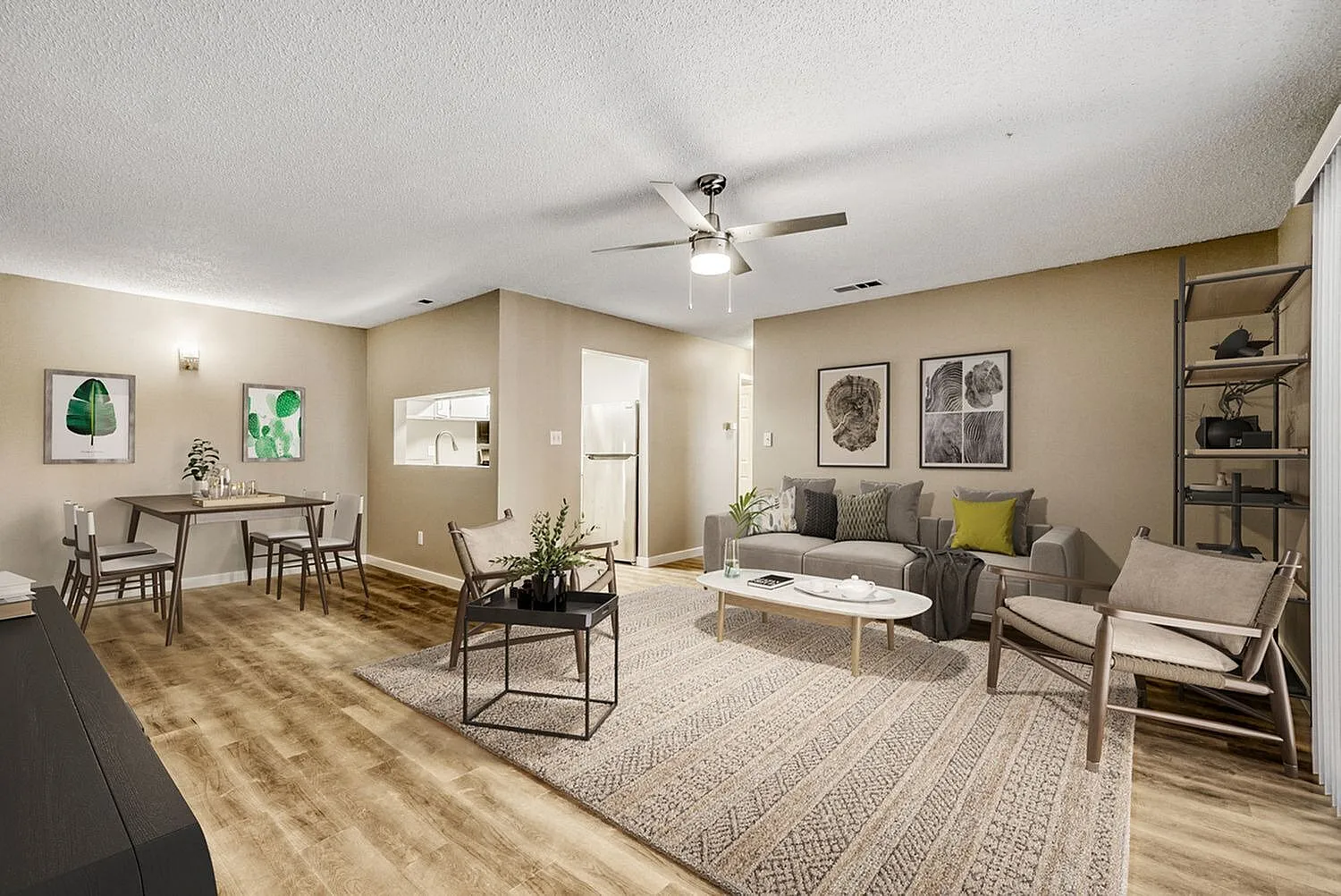 Open concept living area, wood-style plank flooring, ceiling fan, area rug, dining space