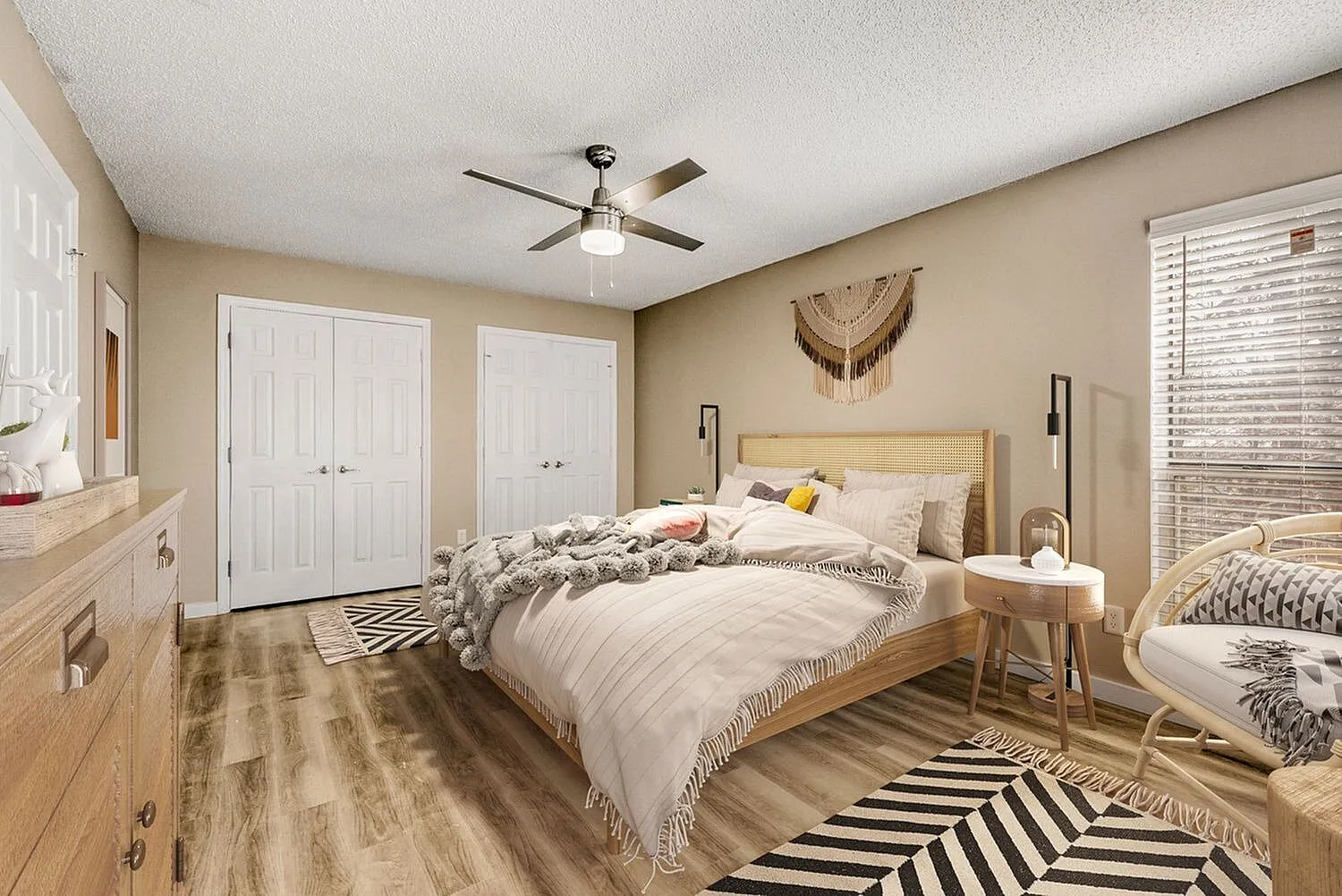 Primary bedroom, wood-style plank flooring, ceiling fan, wooden bed frame, neutral bedding