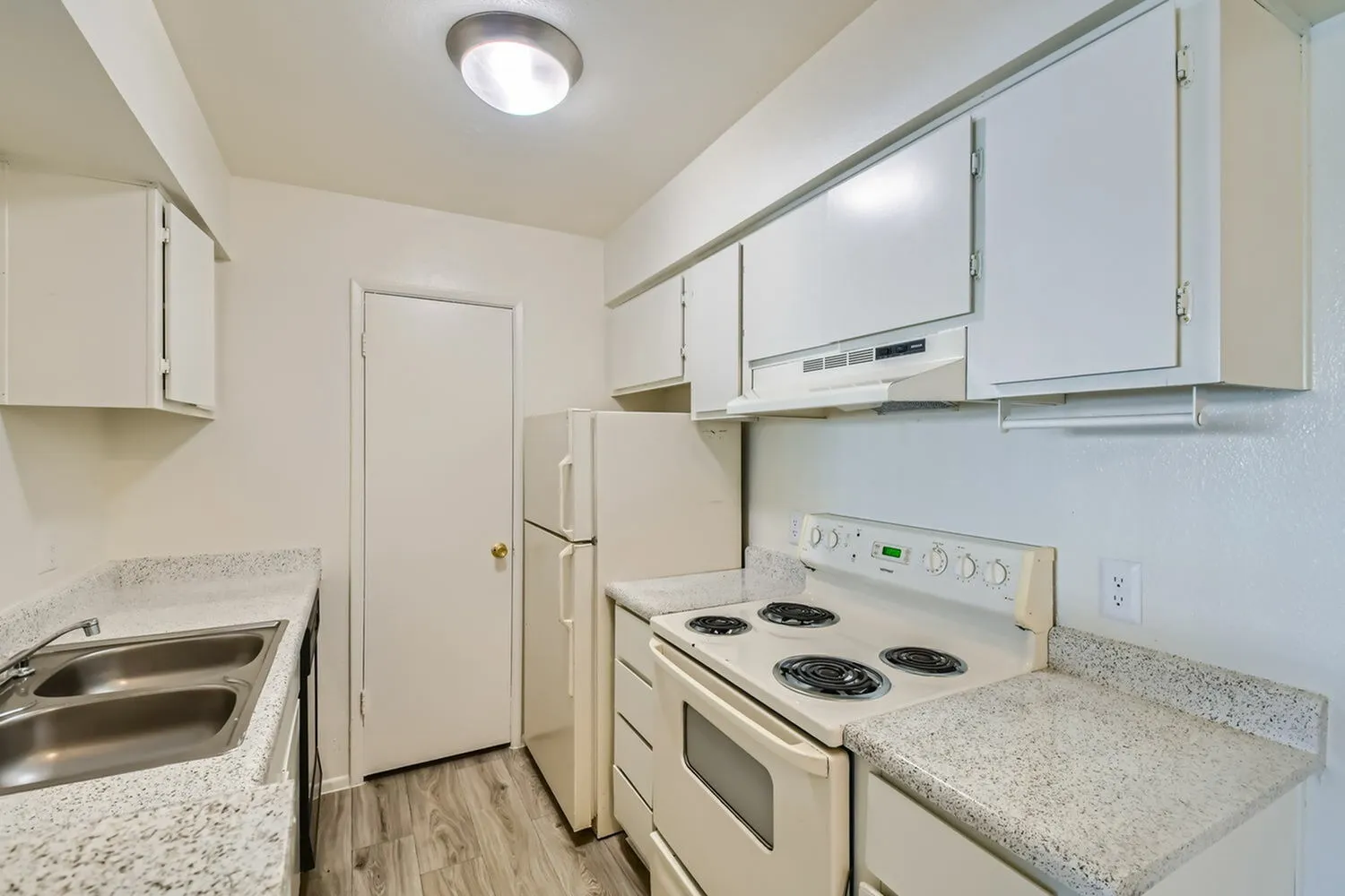 Kitchen, white cabinetry, granite countertops, white electric range, wood-style plank flooring