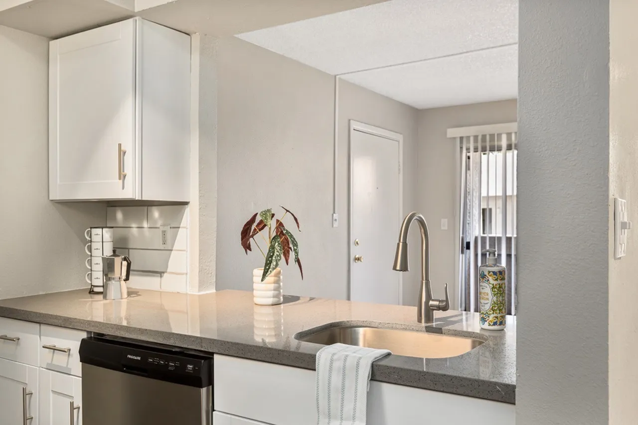 Kitchen, white shaker cabinetry, gray quartz countertops, stainless steel appliances