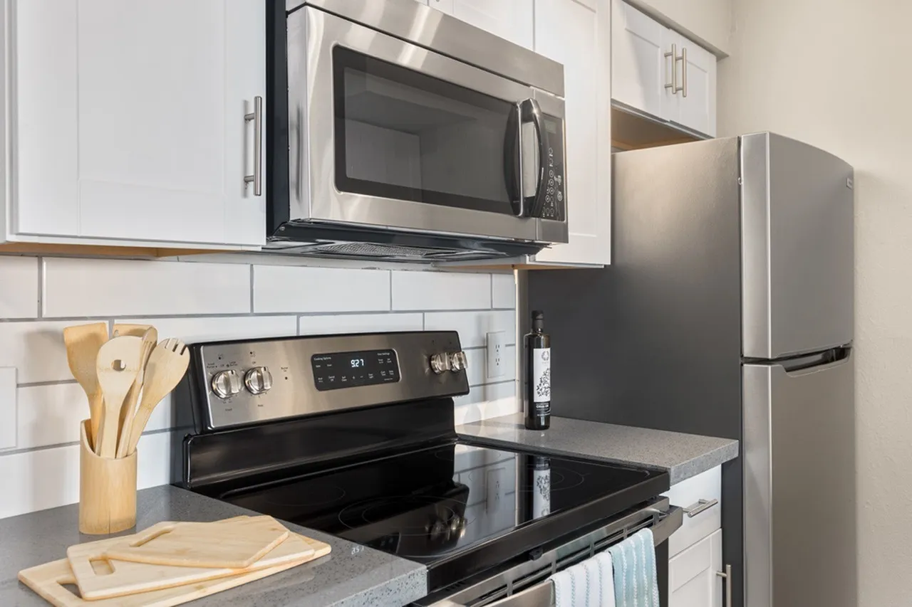 Kitchen, white shaker cabinetry, gray quartz countertops, stainless steel appliances, subway tile backsplash