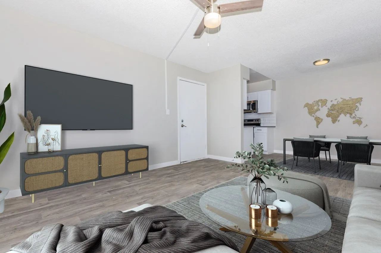 Living room, wood-style plank flooring, wall-mounted TV, rattan media console, ceiling fan