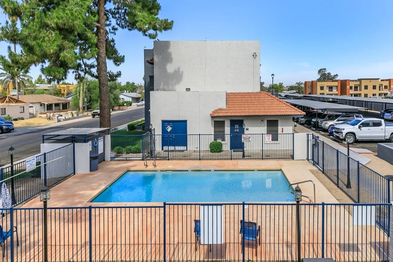 Swimming pool, metal fencing, terracotta pavers, community building, parking area