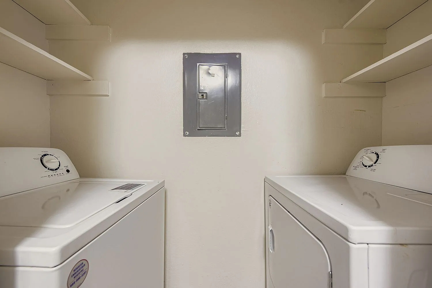 Laundry room, white washer and dryer, electrical panel, recessed lighting