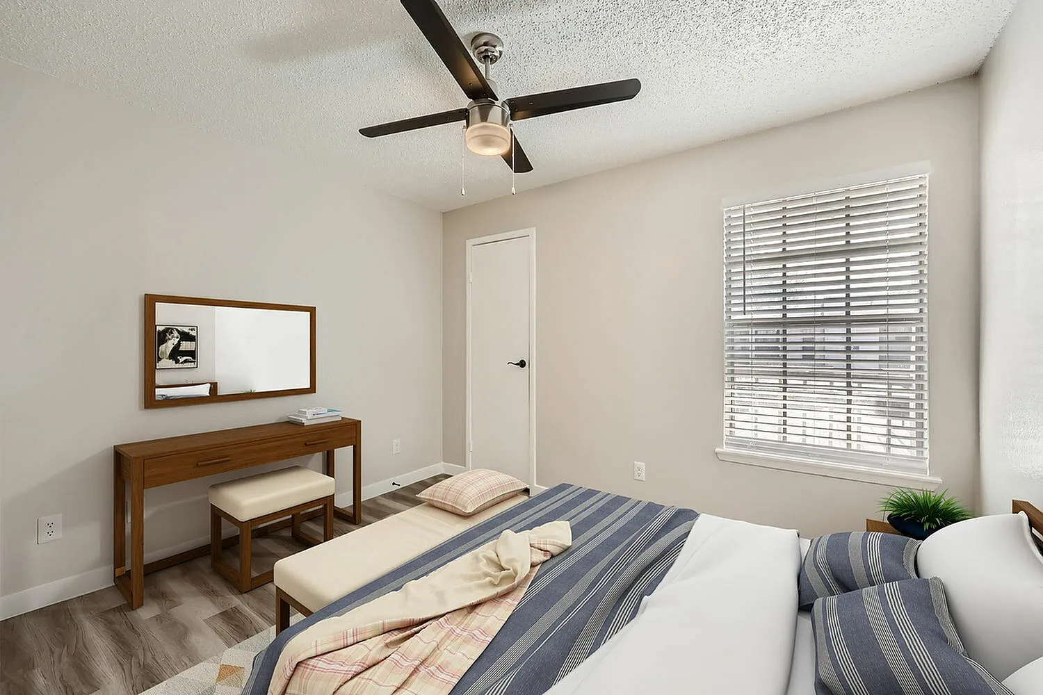 Primary bedroom, wood-style plank flooring, ceiling fan with light fixture, plantation shutters, wood furniture
