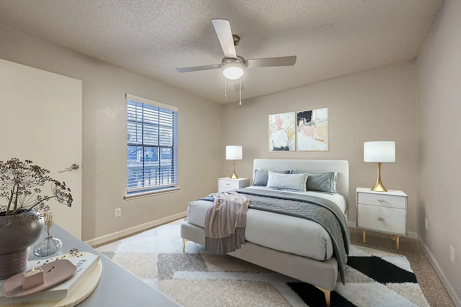 Primary bedroom, upholstered bed, wood nightstands, ceiling fan with light, large window