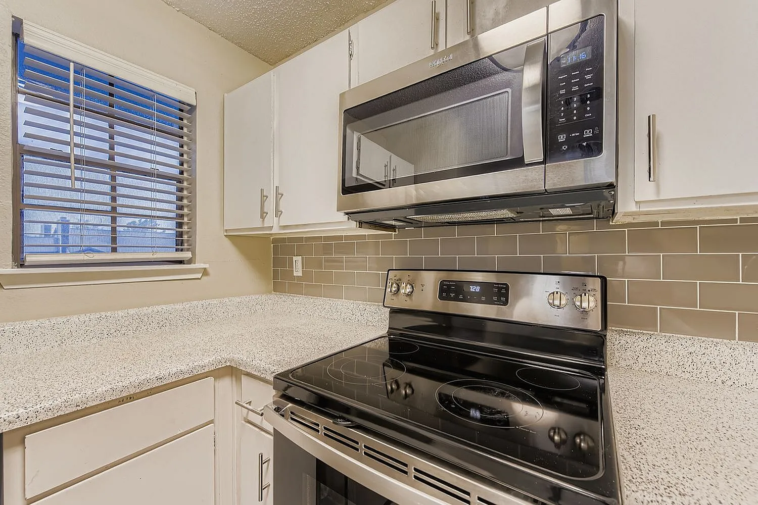 Kitchen, white shaker cabinetry, quartz countertops, stainless steel appliances, subway tile backsplash