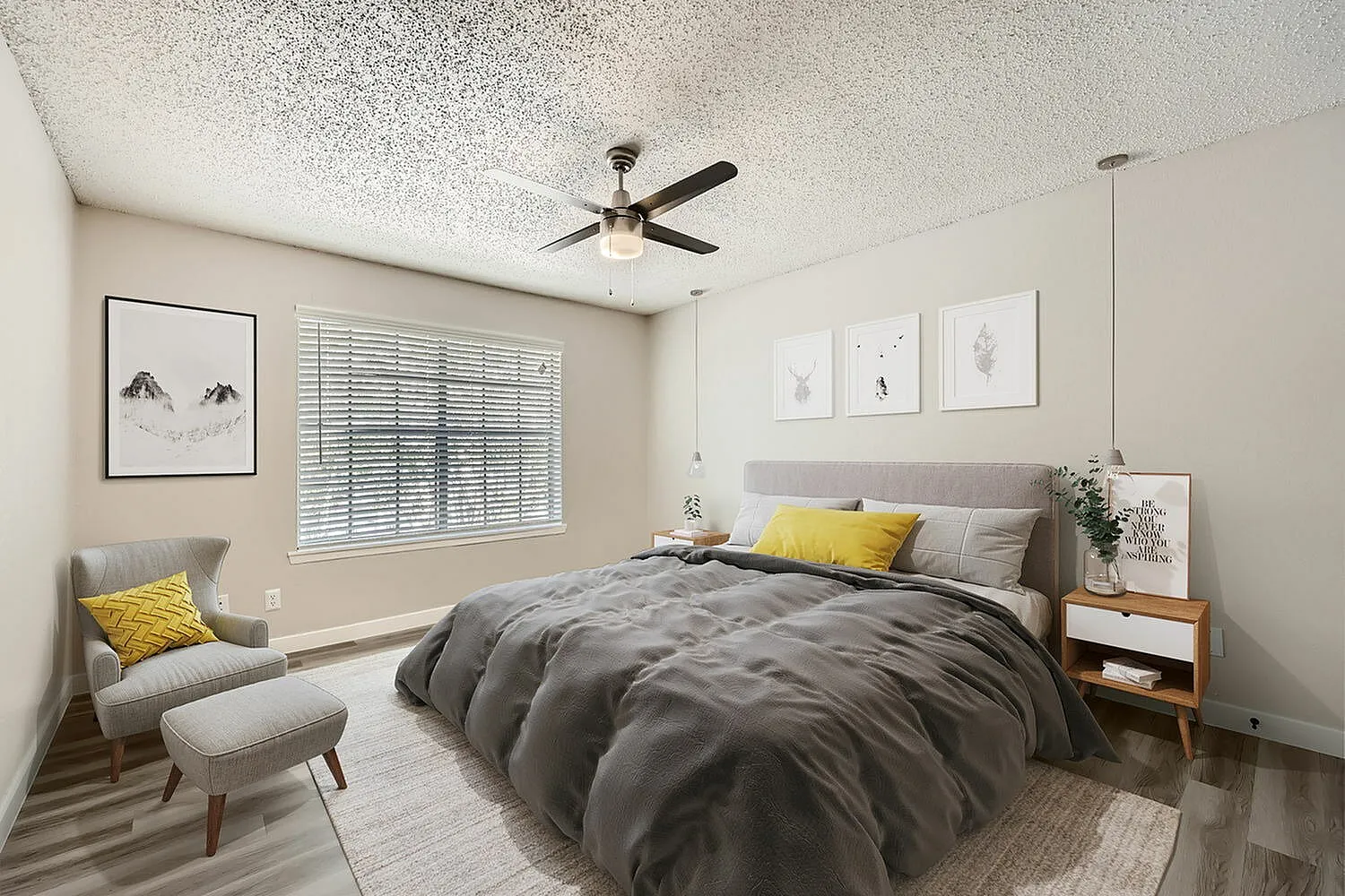 Primary bedroom, wood-style plank flooring, ceiling fan, gray upholstered headboard, yellow accent pillows
