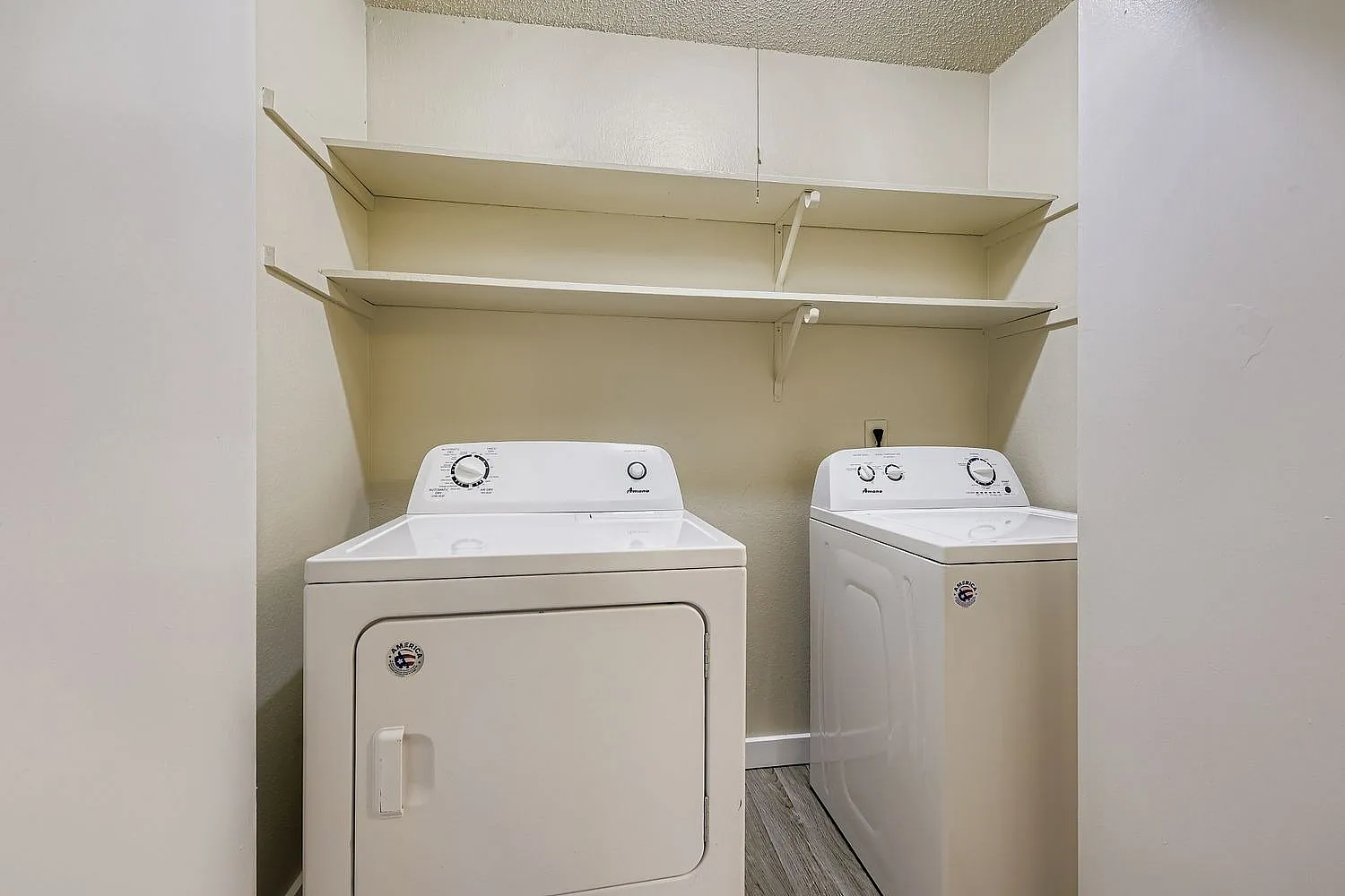 Laundry room, white washer and dryer, open shelving, wood-style plank flooring