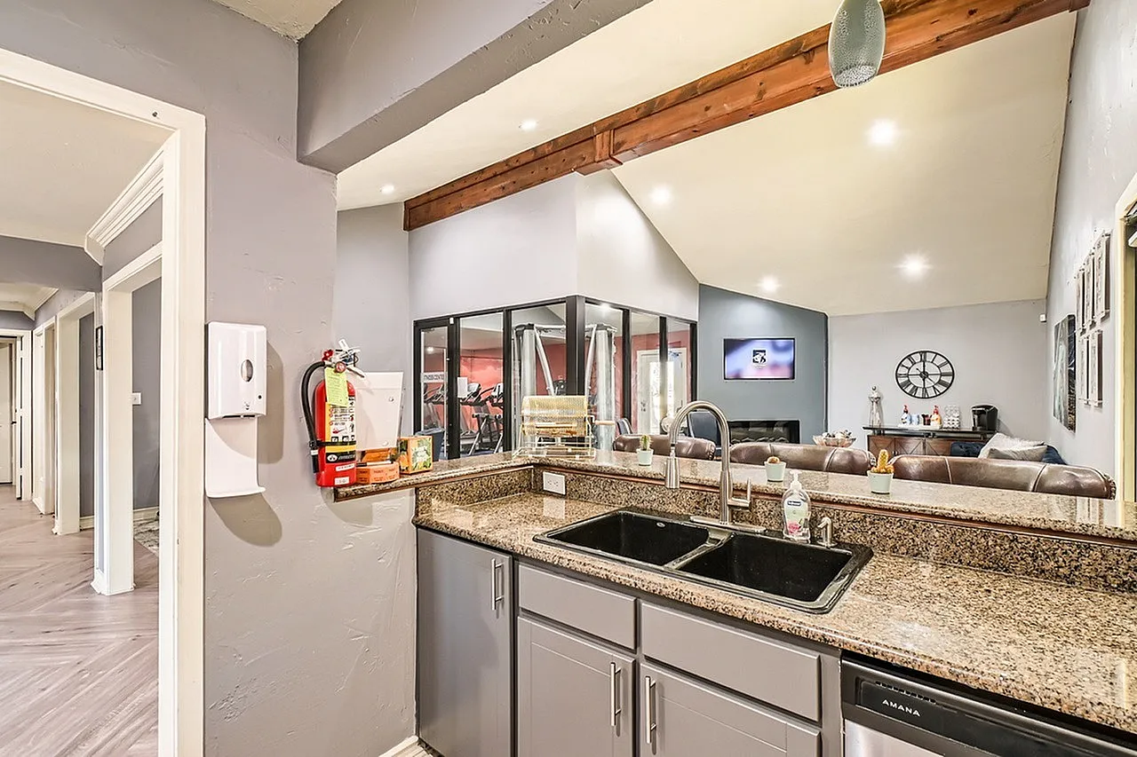 Kitchen, granite countertops, stainless appliances, gray cabinetry, wood beam ceiling