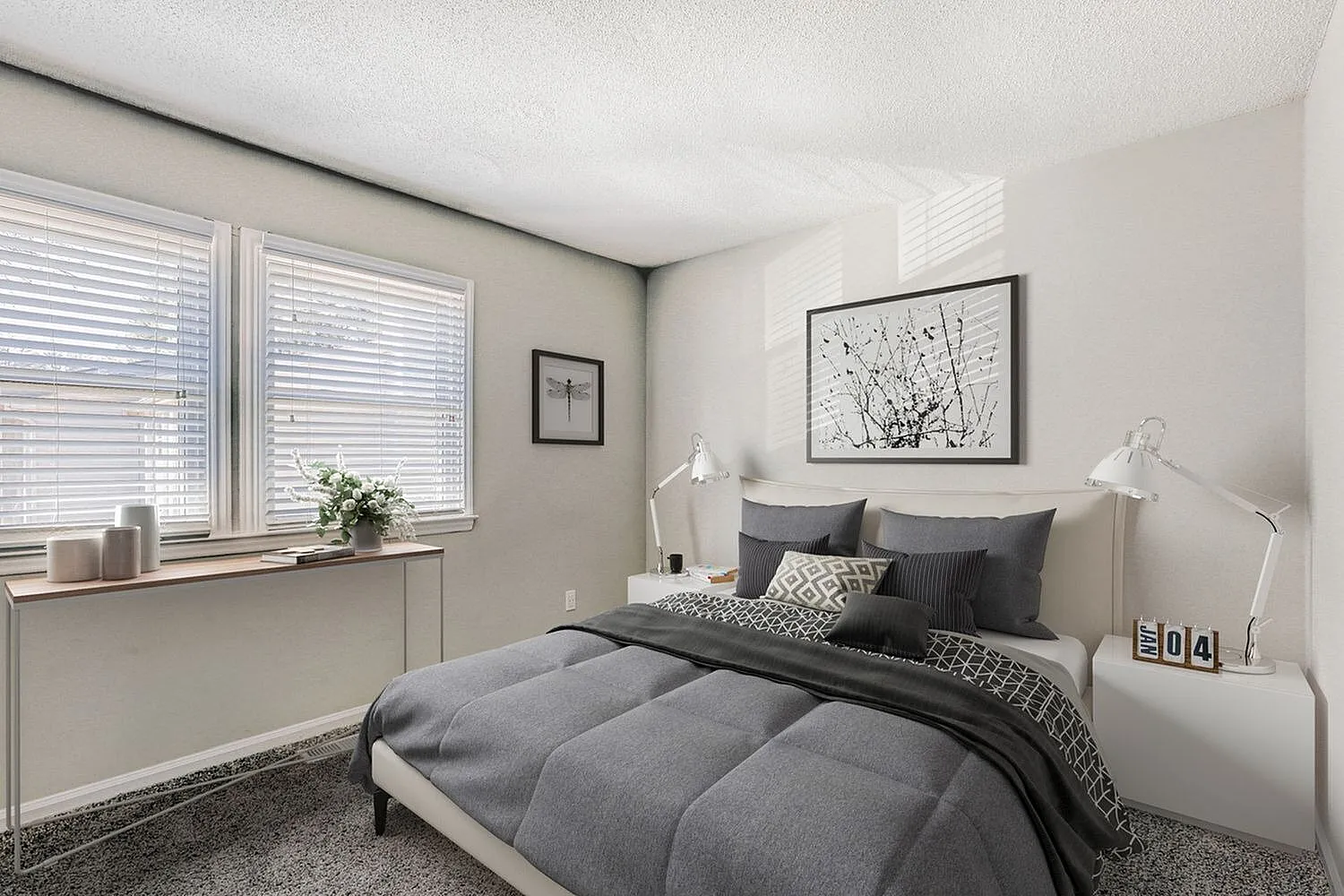 Primary bedroom, gray upholstered bed, wood-style plank flooring, white venetian blinds, framed wall art