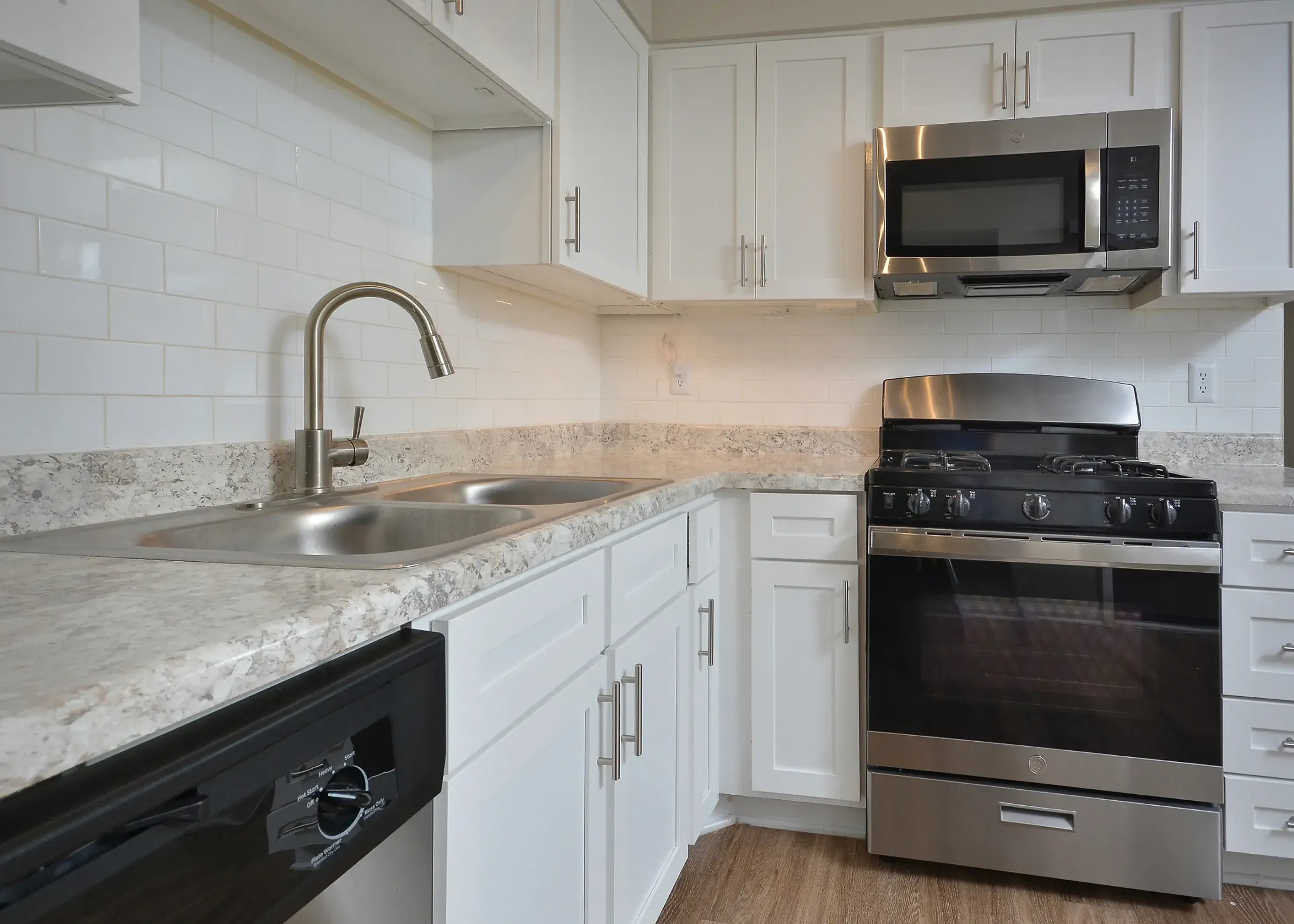 Kitchen, white shaker cabinetry, quartz countertops, stainless appliances, white subway tile backsplash